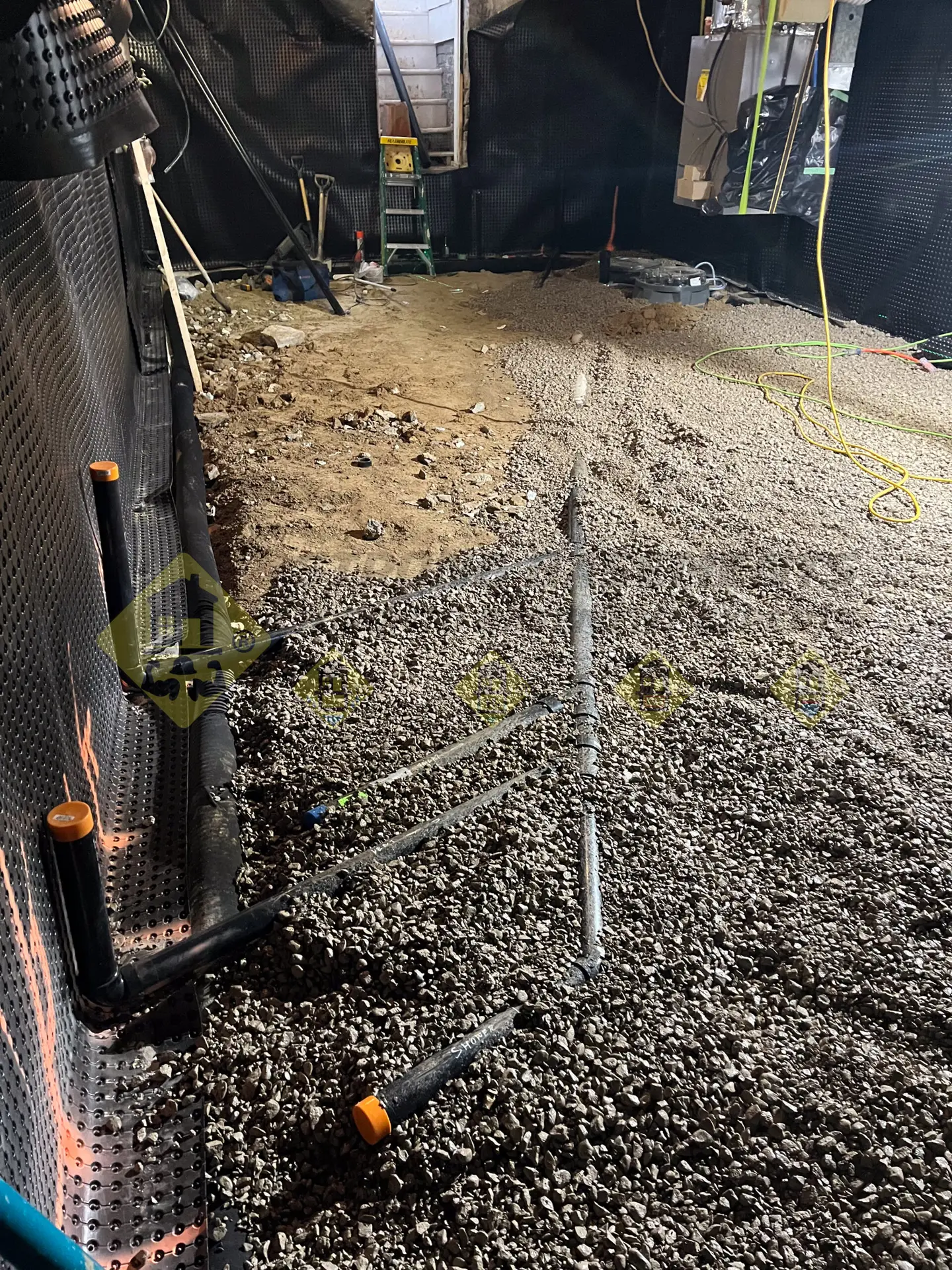 Installed ABS drainage pipe rough-ins for a new 3-piece washroom, securely connected and sloped toward a sewage ejector pump in a lowered Leaside, Toronto basement.