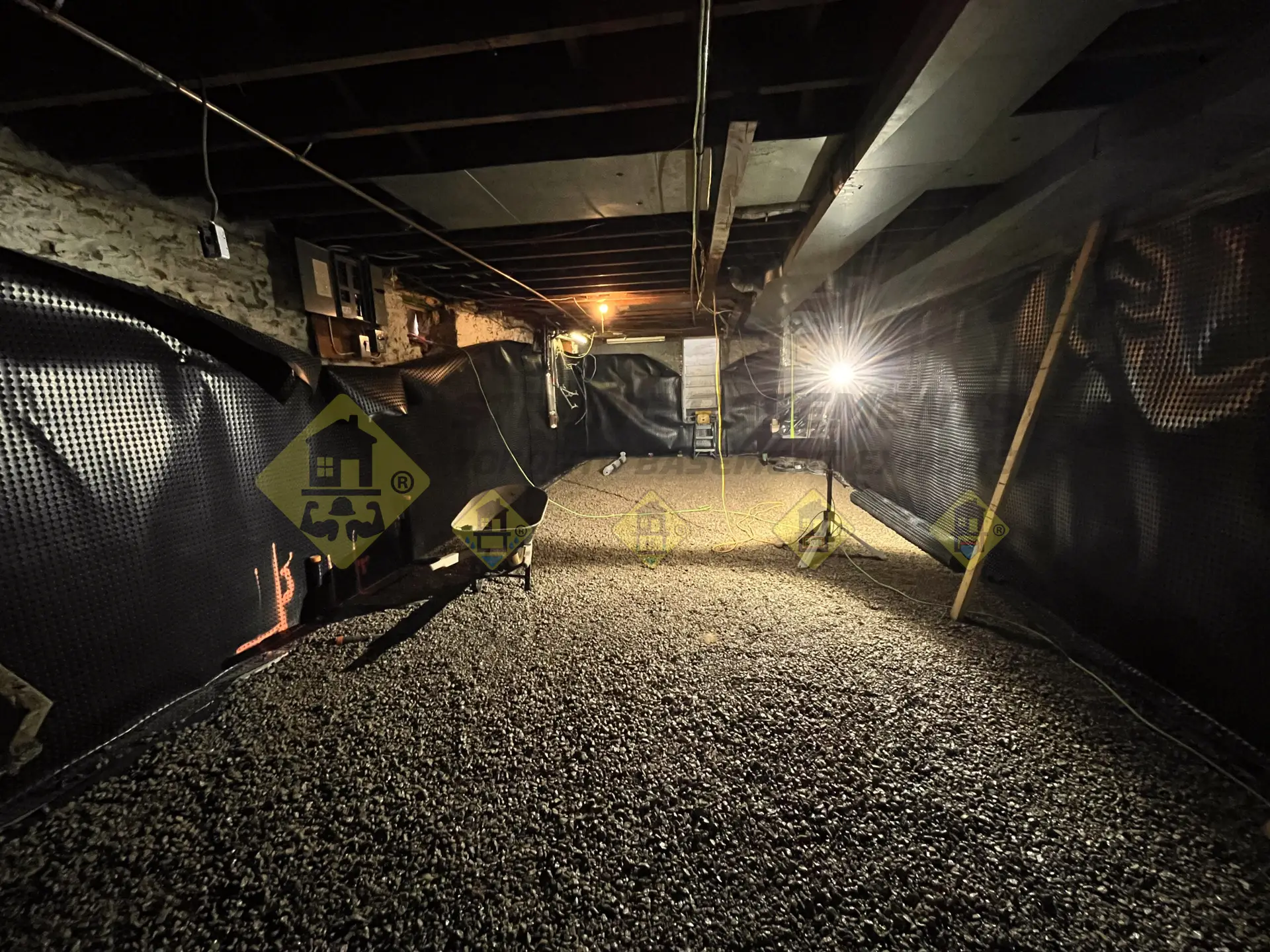 A fully underpinned basement featuring interior waterproofing, installed drainage pipes, and a fully compacted 4-inch gravel bedding ready for a concrete floor pour in Leaside, Toronto.