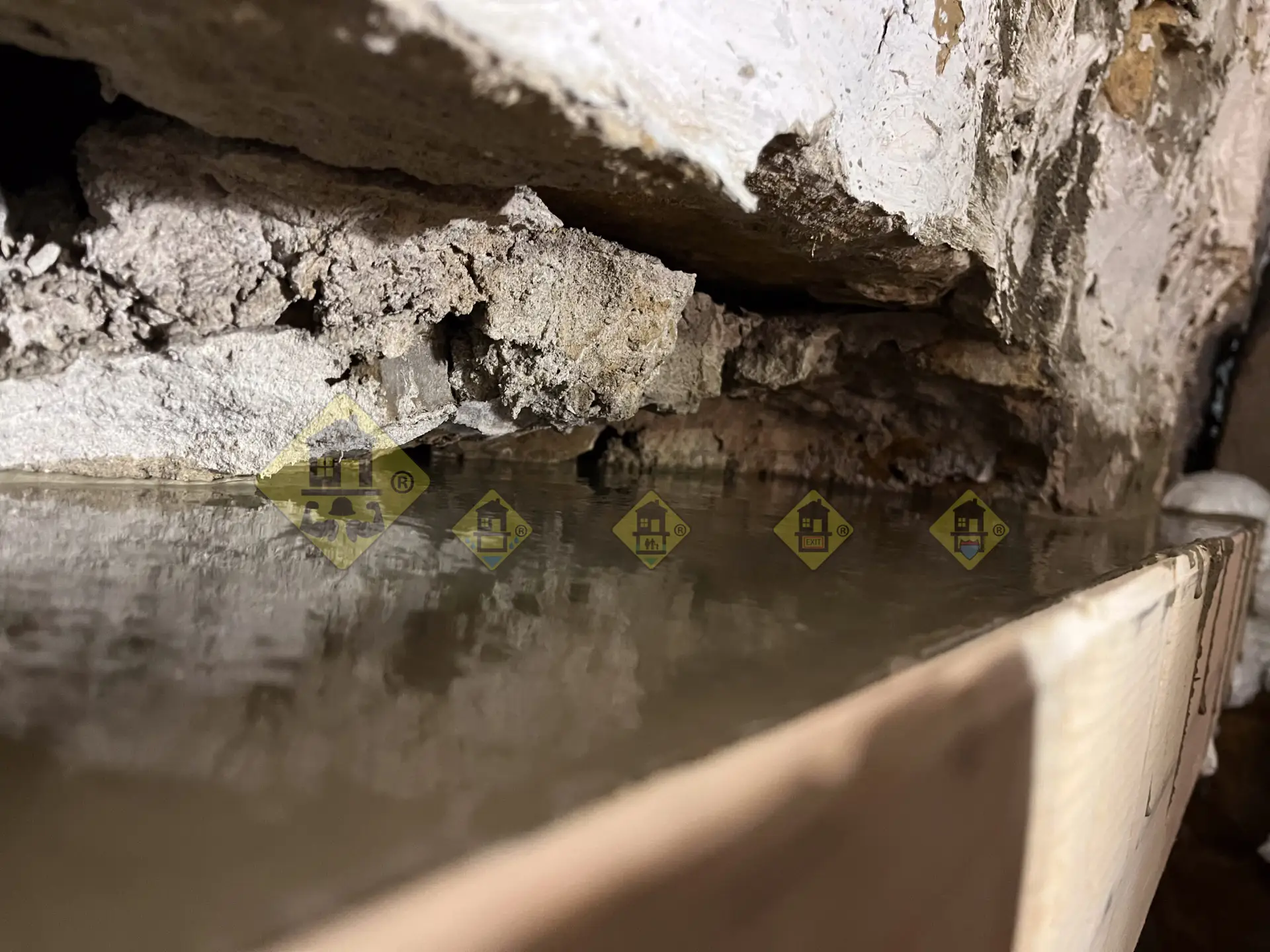 Liquid non-shrink grout with a flat surface poured into a form, penetrating all voids and gaps in the original stone footing during a Leaside basement underpinning project.